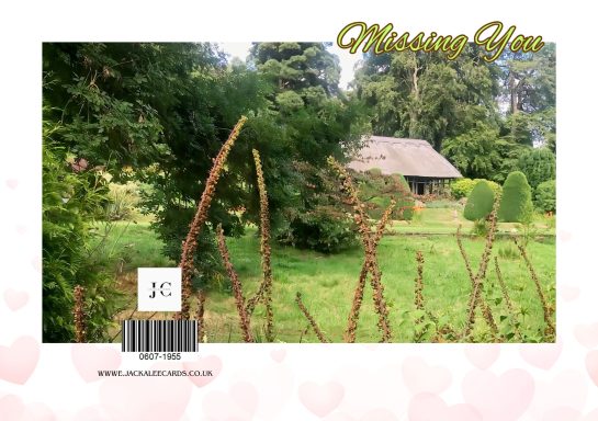 A serene garden scene with a cottage and greenery, overlaid with the text "Missing You."