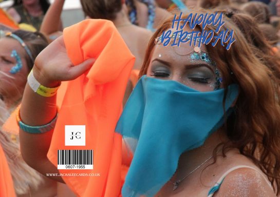 Person with orange fabric and blue face covering at a festive event.