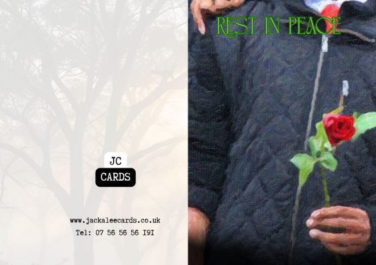 JC 0036 A person holding a red rose against a blurred, forested background.