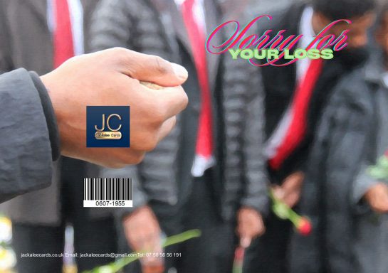A hand holds a rose, with several people in suits and ties blurred in the background.