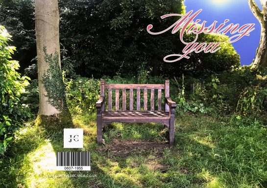 A wooden bench surrounded by lush greenery with "Missing you" text above.