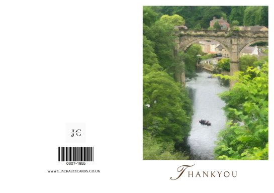 River winding through lush greenery with a stone bridge in the background.
