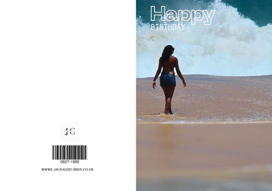 A woman walking along a beach with waves in the background.